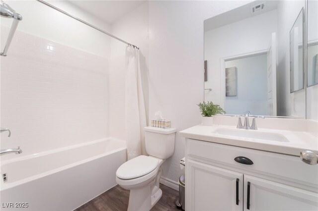 bathroom featuring vanity, shower / bath combo with shower curtain, toilet, wood finished floors, and visible vents