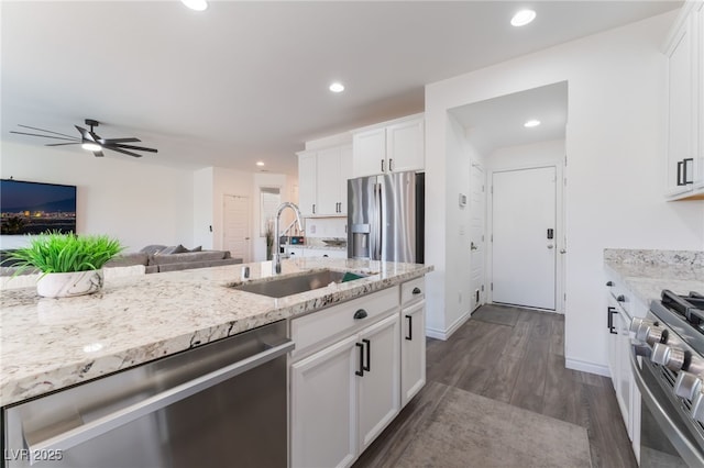 7132 Sayonara Vista St, North Las Vegas, NV 89084 - kitchen featuring stainless steel appliances, a sink, dark wood-style flooring, a ceiling fan, and open floor plan