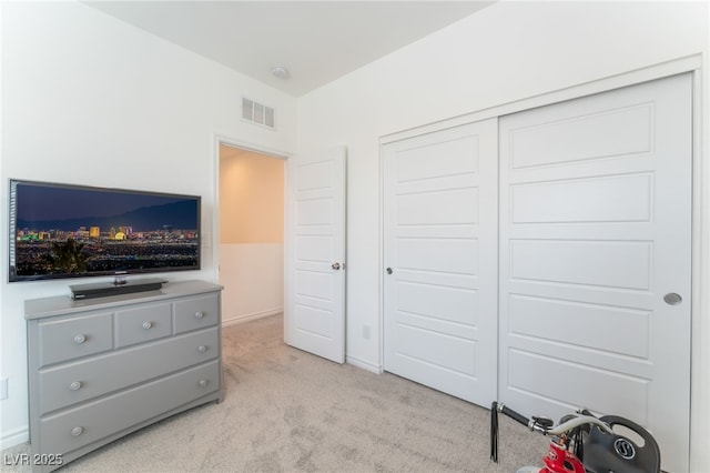 bedroom featuring visible vents, a closet, and light colored carpet