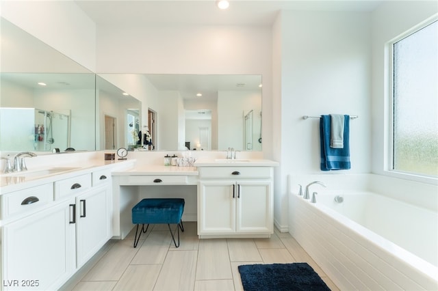 bathroom featuring vanity, a shower stall, recessed lighting, and a garden tub
