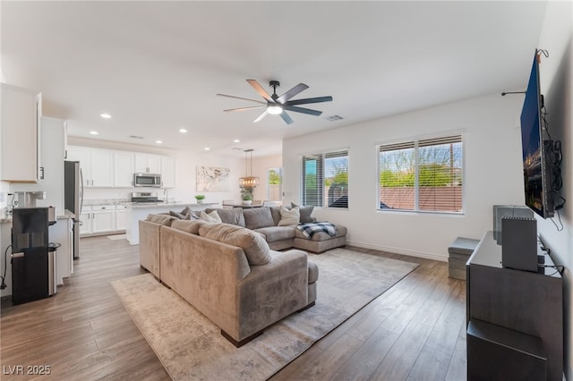 7132 Sayonara Vista St, North Las Vegas, NV 89084 - living room featuring a ceiling fan, wood finished floors, recessed lighting, and baseboards
