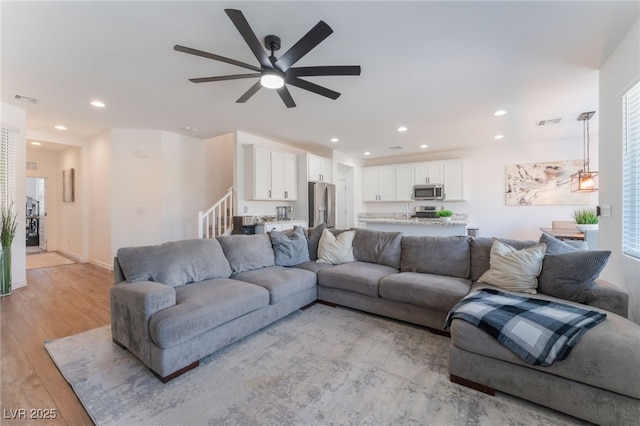 living room with visible vents, recessed lighting, light wood-style floors, and ceiling fan
