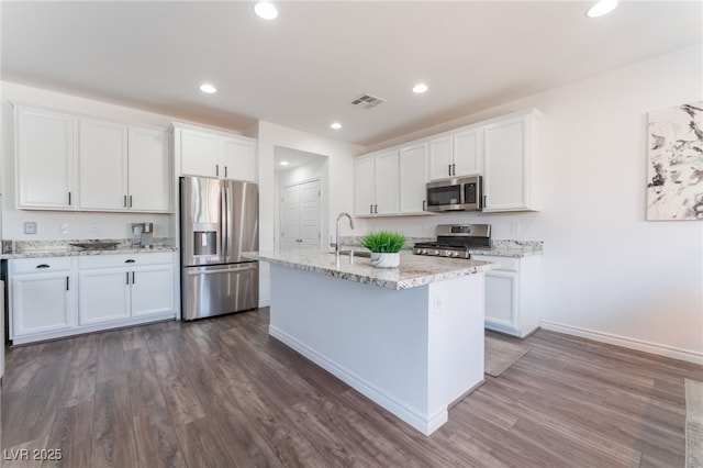 kitchen with white cabinetry, appliances with stainless steel finishes, dark wood-style floors, and visible vents