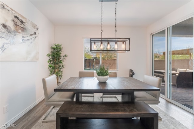 dining area with light wood-style floors and baseboards