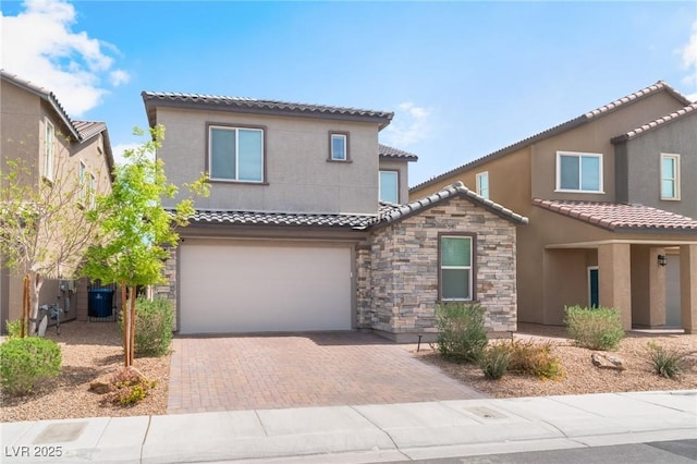 7132 Sayonara Vista St, North Las Vegas, NV 89084 - mediterranean / spanish-style home featuring stucco siding, an attached garage, a tiled roof, decorative driveway, and stone siding