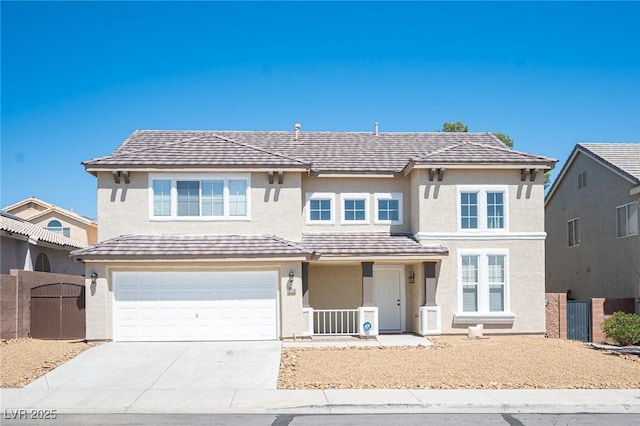 traditional home featuring a garage, fence, stucco siding, a gate, and driveway