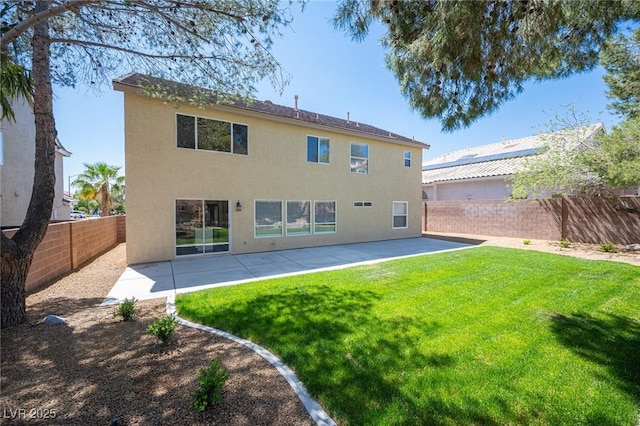 back of house featuring a patio, stucco siding, a fenced backyard, and a lawn