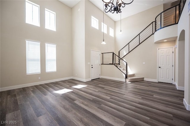unfurnished living room featuring a high ceiling and a healthy amount of sunlight