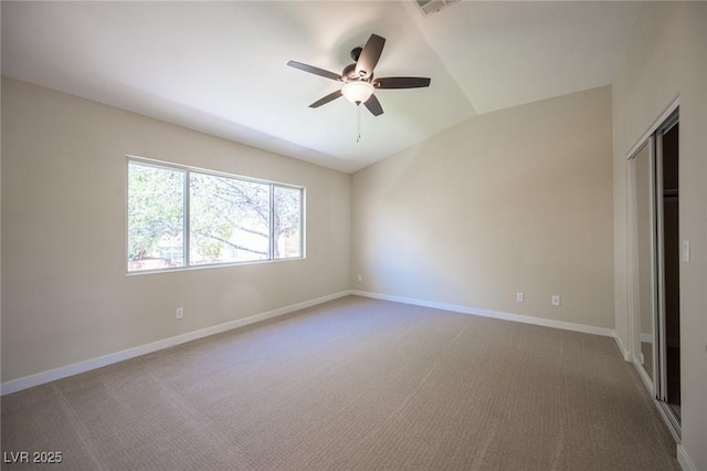 unfurnished bedroom featuring a closet, baseboards, carpet flooring, and lofted ceiling