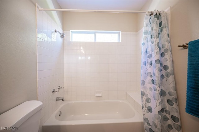 bathroom with toilet and shower / bath combination with curtain
