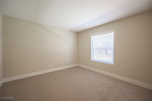 empty room with light carpet and baseboards