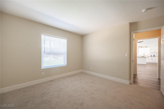 carpeted spare room with baseboards