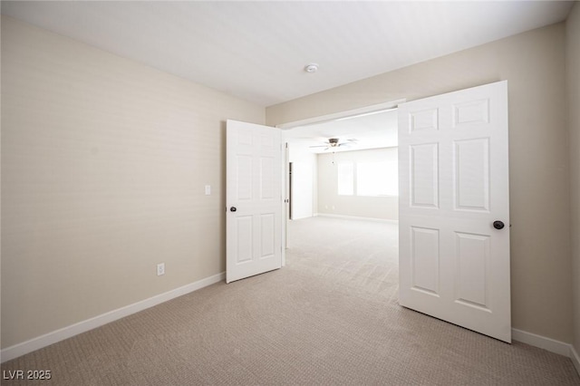 empty room featuring baseboards and carpet