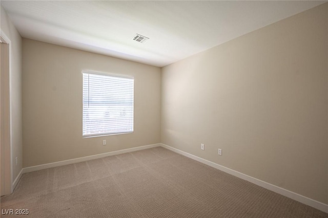 unfurnished room featuring light colored carpet, baseboards, and visible vents