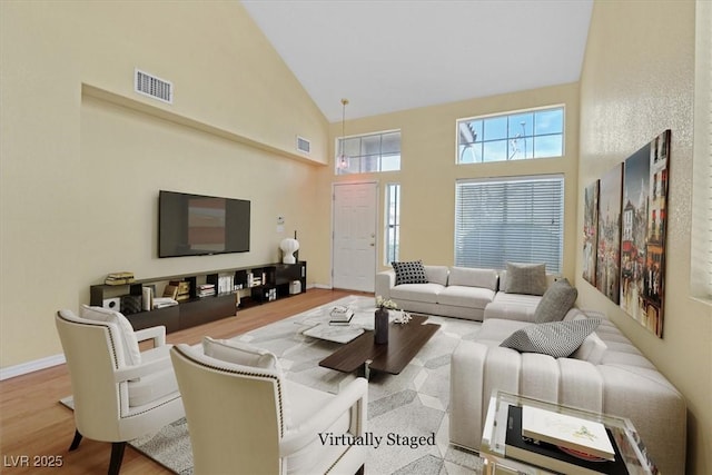 681 Peach Coral St, Las Vegas, NV 89183 - living room featuring high vaulted ceiling, visible vents, and wood finished floors