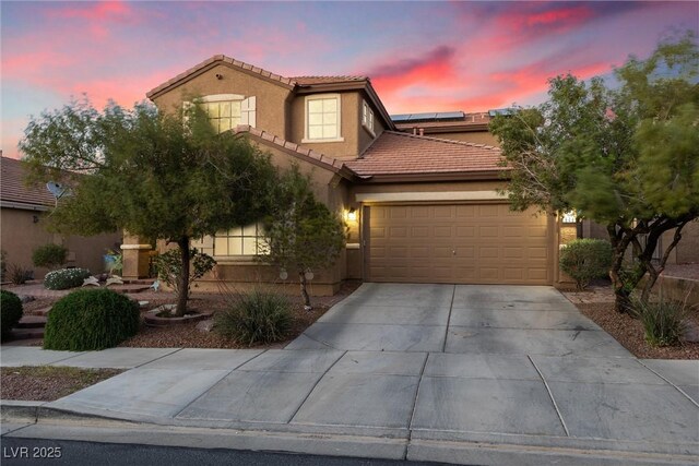 648 Sunrise Lake Pl, Henderson, NV 89002 - mediterranean / spanish house with a garage, stucco siding, driveway, a tile roof, and solar panels