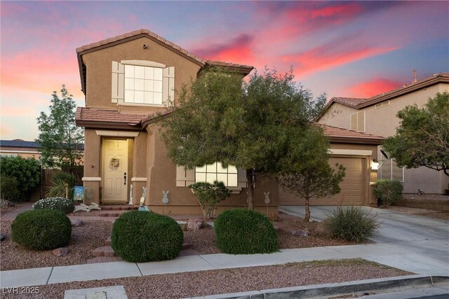648 Sunrise Lake Pl, Henderson, NV 89002 - view of front of property featuring a tiled roof, an attached garage, driveway, and stucco siding