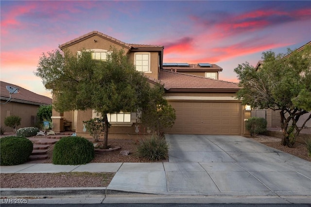 648 Sunrise Lake Pl, Henderson, NV 89002 - view of front of house with an attached garage, a tile roof, stucco siding, roof mounted solar panels, and concrete driveway