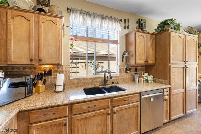 648 Sunrise Lake Pl, Henderson, NV 89002 - kitchen featuring stainless steel dishwasher, backsplash, a sink, and light countertops