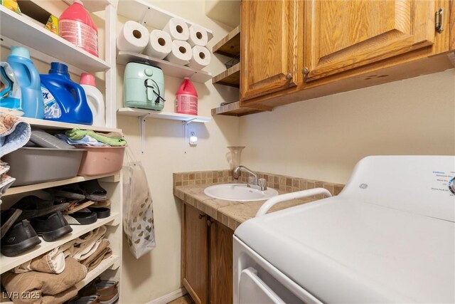 648 Sunrise Lake Pl, Henderson, NV 89002 - clothes washing area featuring washer / dryer, cabinet space, and a sink