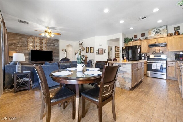648 Sunrise Lake Pl, Henderson, NV 89002 - dining space featuring arched walkways, a ceiling fan, visible vents, and light wood-style flooring