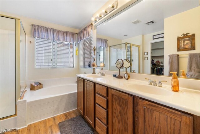 648 Sunrise Lake Pl, Henderson, NV 89002 - bathroom featuring a sink, a shower stall, a garden tub, and visible vents