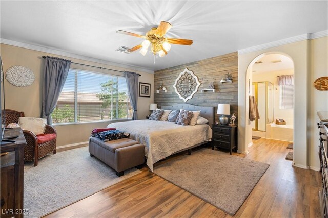 648 Sunrise Lake Pl, Henderson, NV 89002 - bedroom with visible vents, crown molding, arched walkways, wood finished floors, and baseboards