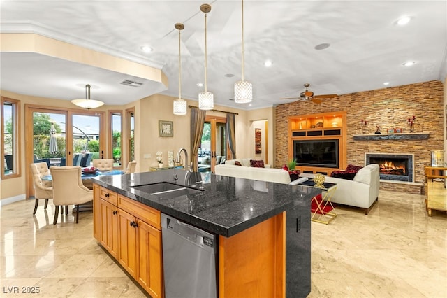 9 Contra Costa Pl, Henderson, NV 89052 - kitchen with a kitchen island with sink, a sink, visible vents, dishwasher, and a stone fireplace