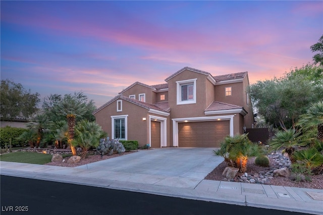 9 Contra Costa Pl, Henderson, NV 89052 - view of front of home featuring an attached garage, a tile roof, driveway, and stucco siding