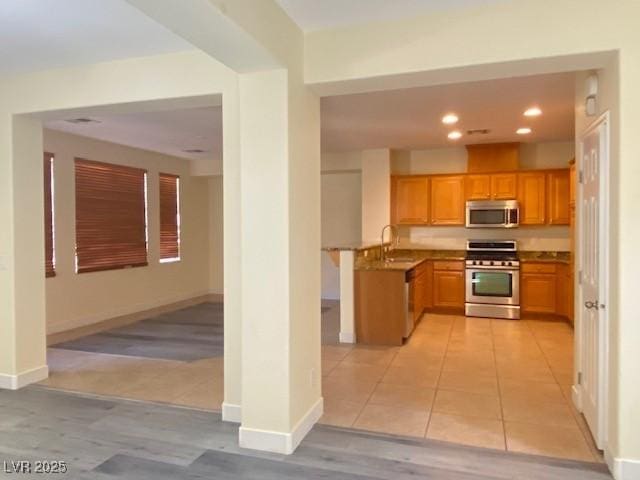 8374 Pioneer Way, Las Vegas, NV 89113 - kitchen featuring baseboards, recessed lighting, light tile patterned floors, appliances with stainless steel finishes, and a sink