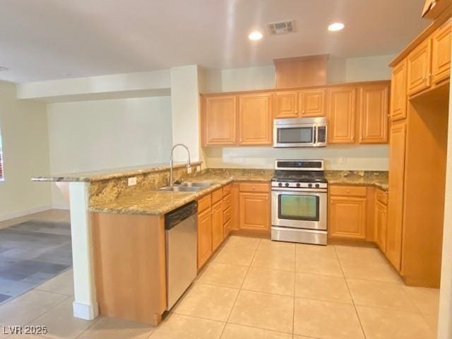 8374 Pioneer Way, Las Vegas, NV 89113 - kitchen featuring a sink, light tile patterned flooring, a peninsula, and stainless steel appliances