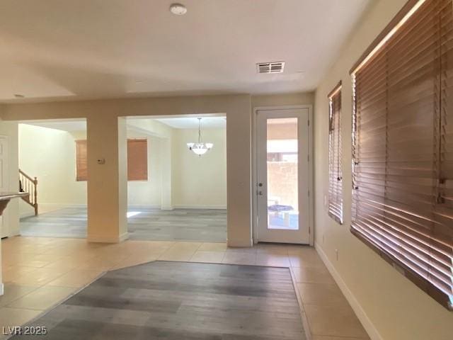 8374 Pioneer Way, Las Vegas, NV 89113 - interior space featuring baseboards, a chandelier, stairway, light wood-style flooring, and visible vents