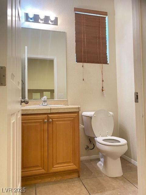 8374 Pioneer Way, Las Vegas, NV 89113 - half bath with toilet, vanity, and tile patterned flooring