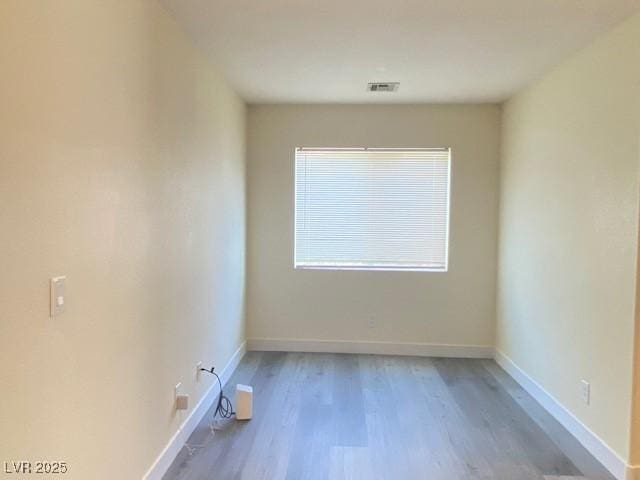 8374 Pioneer Way, Las Vegas, NV 89113 - empty room featuring visible vents, baseboards, and wood finished floors