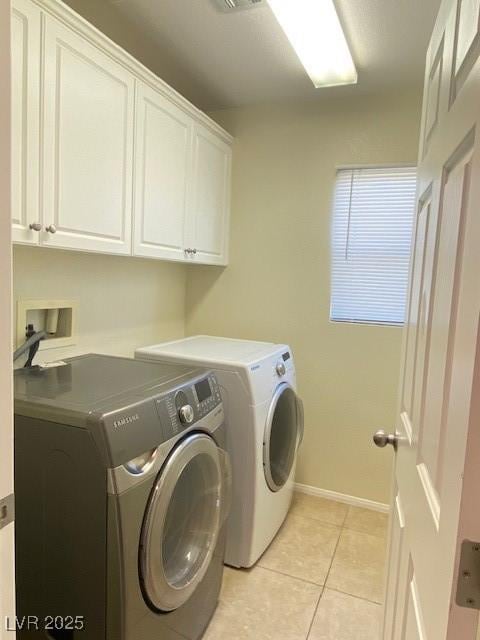 8374 Pioneer Way, Las Vegas, NV 89113 - washroom with baseboards, light tile patterned flooring, visible vents, cabinet space, and washer and dryer