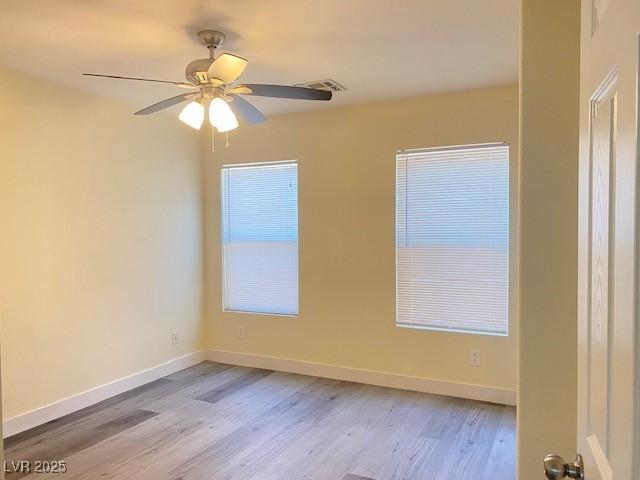 8374 Pioneer Way, Las Vegas, NV 89113 - empty room with wood finished floors, baseboards, and ceiling fan