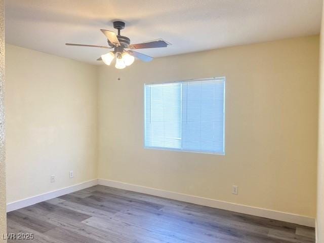 8374 Pioneer Way, Las Vegas, NV 89113 - spare room with ceiling fan, baseboards, and wood finished floors