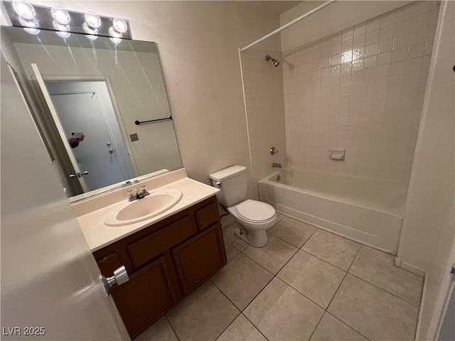 bathroom featuring washtub / shower combination, toilet, vanity, and tile patterned flooring