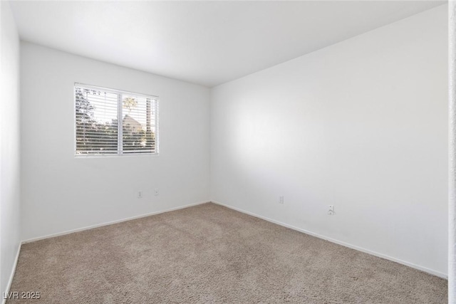 carpeted spare room with baseboards