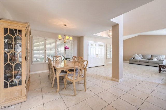 dining room with light tile patterned floors, a notable chandelier, and baseboards
