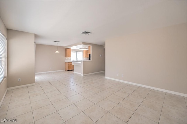 empty room featuring light tile patterned floors, baseboards, and visible vents