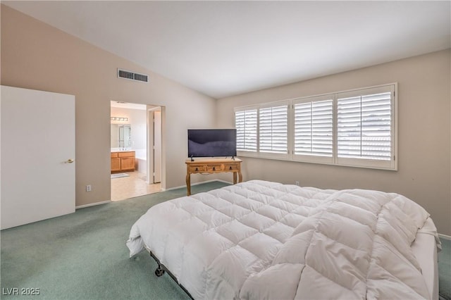 bedroom featuring carpet flooring, vaulted ceiling, visible vents, and connected bathroom