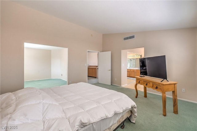 bedroom with baseboards, visible vents, light colored carpet, and vaulted ceiling