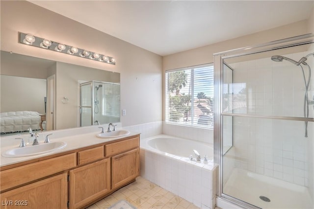 bathroom with a shower stall, double vanity, a garden tub, and a sink