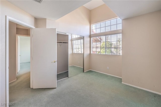 unfurnished bedroom featuring a closet, carpet, and baseboards