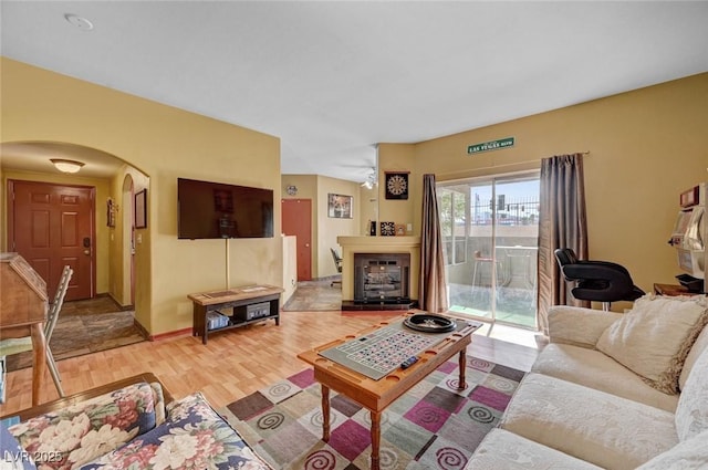 9000 Las Vegas Blvd Unit 1047, Las Vegas, NV 89123 - living area featuring baseboards, arched walkways, a fireplace with raised hearth, and light wood-style flooring
