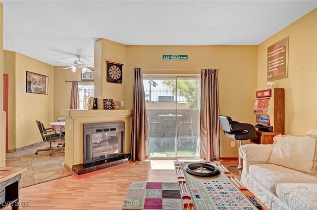 9000 Las Vegas Blvd Unit 1047, Las Vegas, NV 89123 - living room featuring a ceiling fan, light wood-style flooring, and a glass covered fireplace
