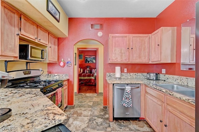 9000 Las Vegas Blvd Unit 1047, Las Vegas, NV 89123 - kitchen featuring light stone counters, light brown cabinetry, stone finish floor, appliances with stainless steel finishes, and visible vents