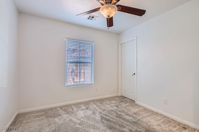 unfurnished room with carpet flooring, visible vents, baseboards, and ceiling fan
