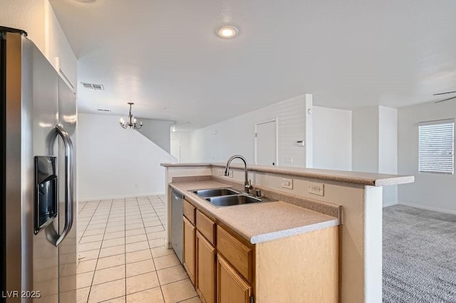 kitchen with visible vents, a sink, light countertops, stainless steel appliances, and light tile patterned flooring